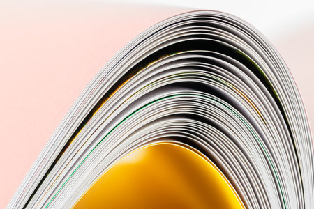 close up of a stack of magazines with yellow and white pages.