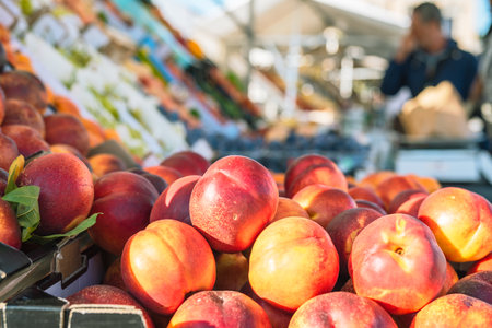 Fresh ripe peaches on the counter of a local fruit market.の写真素材
