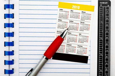 pocket calendar and variety of modern stationery on office desk 