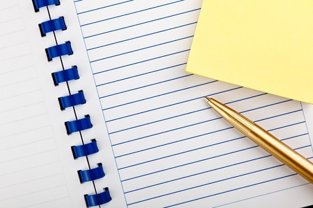 open notebook with placed diagonally ballpoint pen on office desk の写真素材