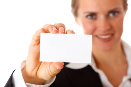 smiling modern business woman holding blank business card isolated on whiteの写真素材