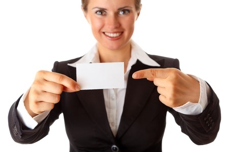 smiling modern business woman pointing finger on blank business card isolated on whiteの写真素材