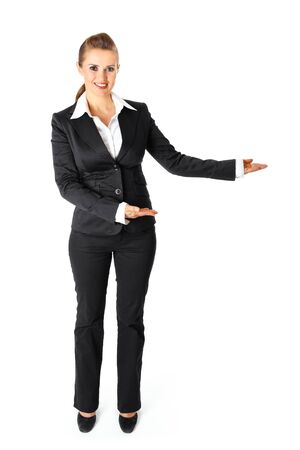 Full length portrait of smiling  business woman presenting something on empty hands isolated on white
の写真素材