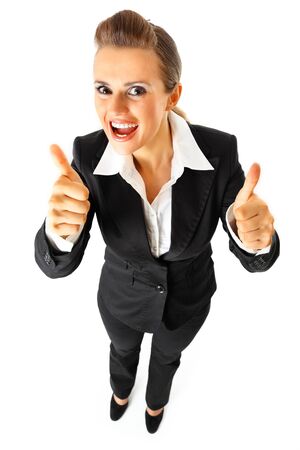  Full length portrait  of pleased modern business woman showing thumbs up gesture  isolated on white
の写真素材
