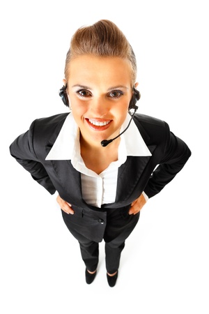 Full length portrait of  smiling telephone operator with headset  isolated on white
の写真素材