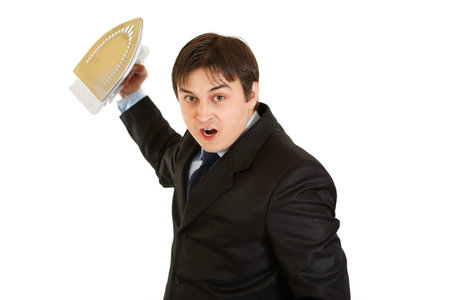 Angry modern businessman menacingly holding iron in hand isolated on whiteの写真素材
