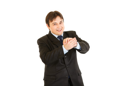 Smiling young businessman cheerfully applauding  isolated on whiteの写真素材
