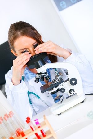 Woman researcher using microscope in medical laboratory. Close-up
の写真素材