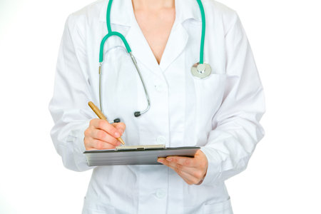 Medical female doctor making notes in document isolated on white. Close-up.