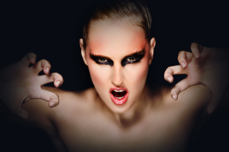 Mysterious young woman with scaring expression. Retouched