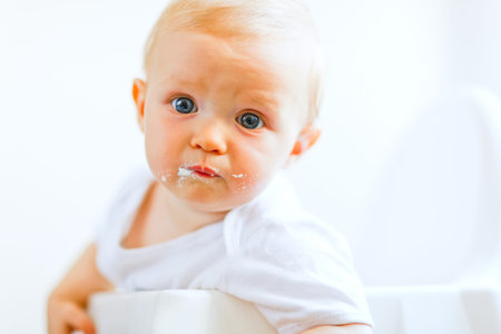 Eat smeared pretty baby girl impressively lookingの写真素材