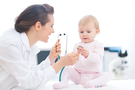 Pediatrician doctor showing baby stethoscopeの写真素材