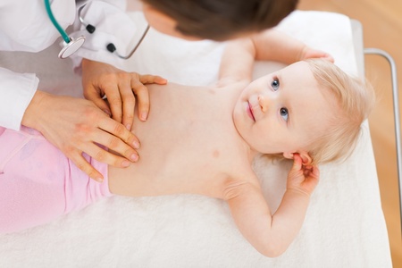Pediatric doctor examine baby. Top viewの写真素材