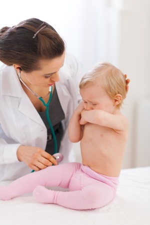 Pediatrician doctor calming crying babyの写真素材