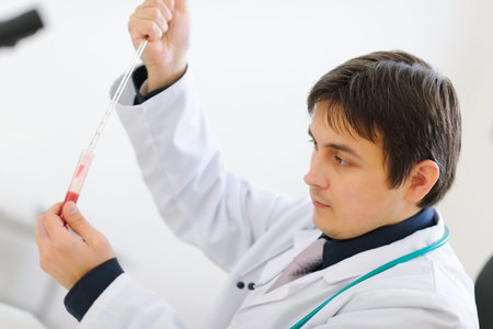 Medical doctor working with blood sample in laboratory