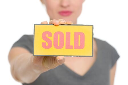Closeup on sold sign holding by female.の写真素材