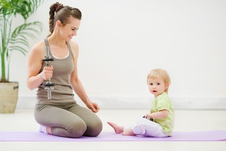 Healthy mother and baby spending time doing fitnessの写真素材