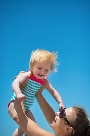 Mother raises baby in airの写真素材