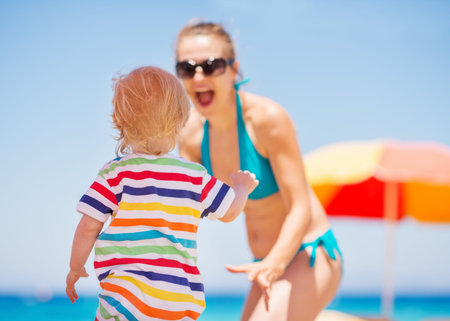 Baby playing with mother. Rear viewの写真素材