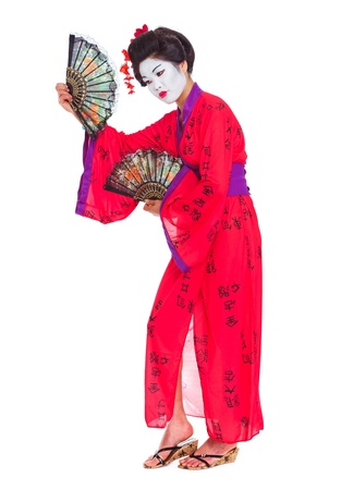Full length portrait of geisha dancing with fans isolated on whiteの写真素材