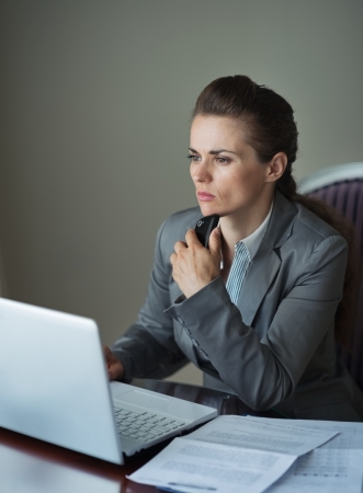 Thoughtful business woman working at hotel roomの写真素材