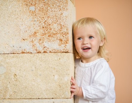 Portrait of baby leaning against wallの写真素材
