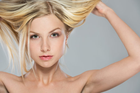 Portrait of blond girl rising up hairの写真素材