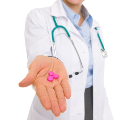 Closeup on medical doctor woman giving pillsの写真素材