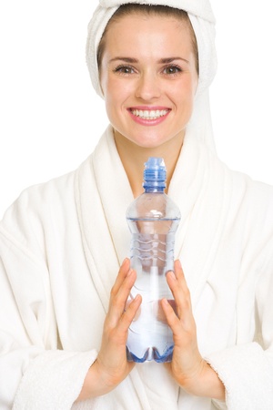 Happy young woman in bathrobe with water bottleの写真素材
