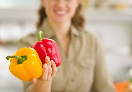 Closeup on fresh bell peppers in hand of young womanの写真素材