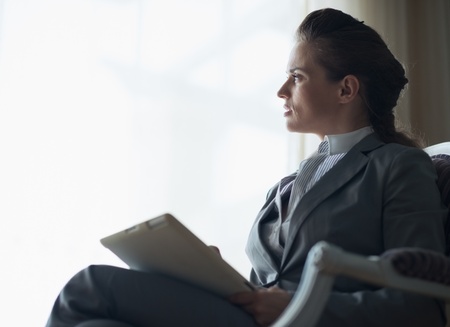 Silhouette of thoughtful business woman with tablet pcの写真素材