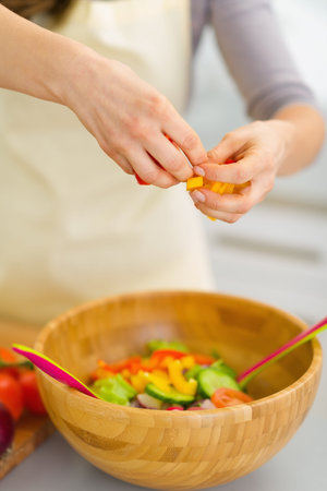 Closeup on housewife preparing vegetable saladの写真素材