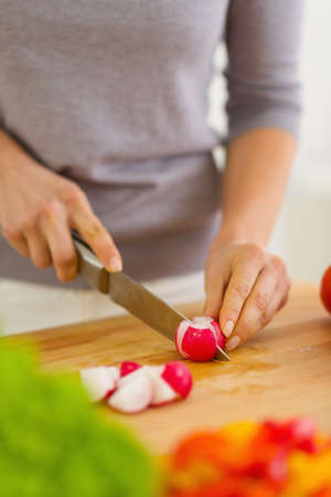 Closeup on woman cutting radishesの写真素材