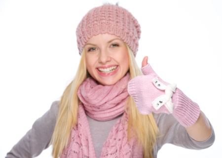Happy girl in winter clothes showing thumbs upの写真素材