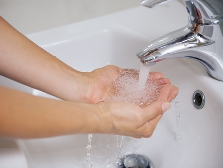 Closeup on woman washing hands in sinkの写真素材