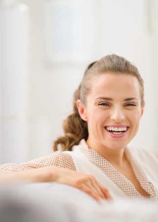 Portrait of happy young housewife in living roomの写真素材