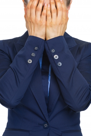 Closeup on stressed business woman closing face with handsの写真素材