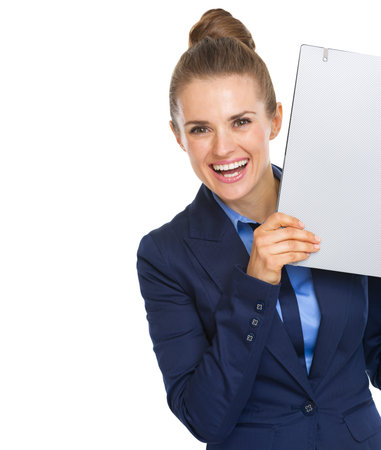 Smiling business woman looking out from folderの写真素材