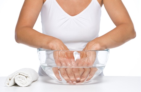 Closeup on woman washing hands in glass bowl with waterの写真素材