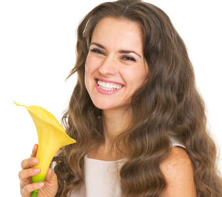 Portrait of smiling young woman with kala flowerの写真素材