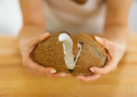 Closeup on young woman opening coconutの写真素材