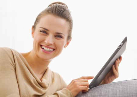 Smiling young woman using tablet pcの写真素材