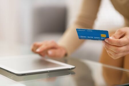 Closeup on woman with credit card using tablet pcの写真素材