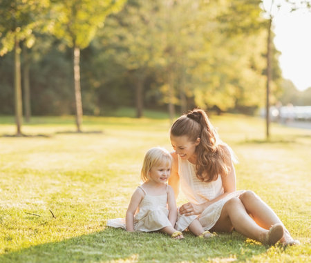 Mother and baby relaxing in parkの写真素材