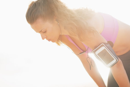 Portrait of fitness young woman catching breathe