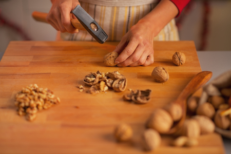 Closeup on young housewife chopping walnutsの写真素材