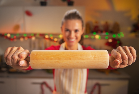 Closeup on young housewife showing rolling pinの写真素材