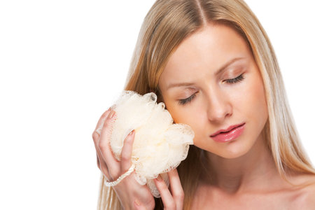 Portrait of relaxed teenage girl holding wisp of bastの写真素材