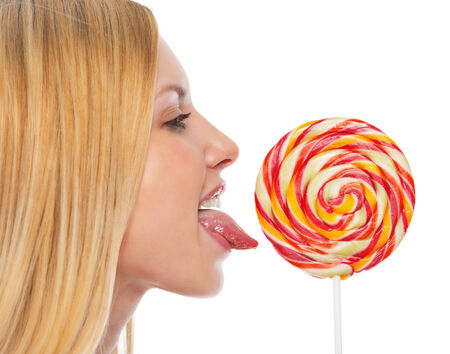 Profile portrait of teenage girl licking lollypopの写真素材