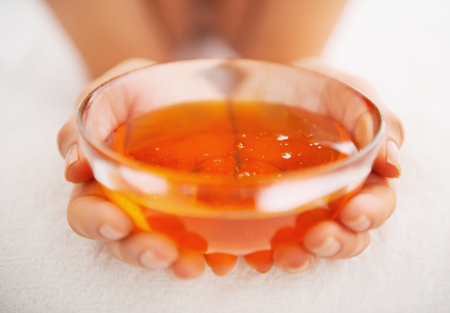 Closeup on young woman showing plate with honey